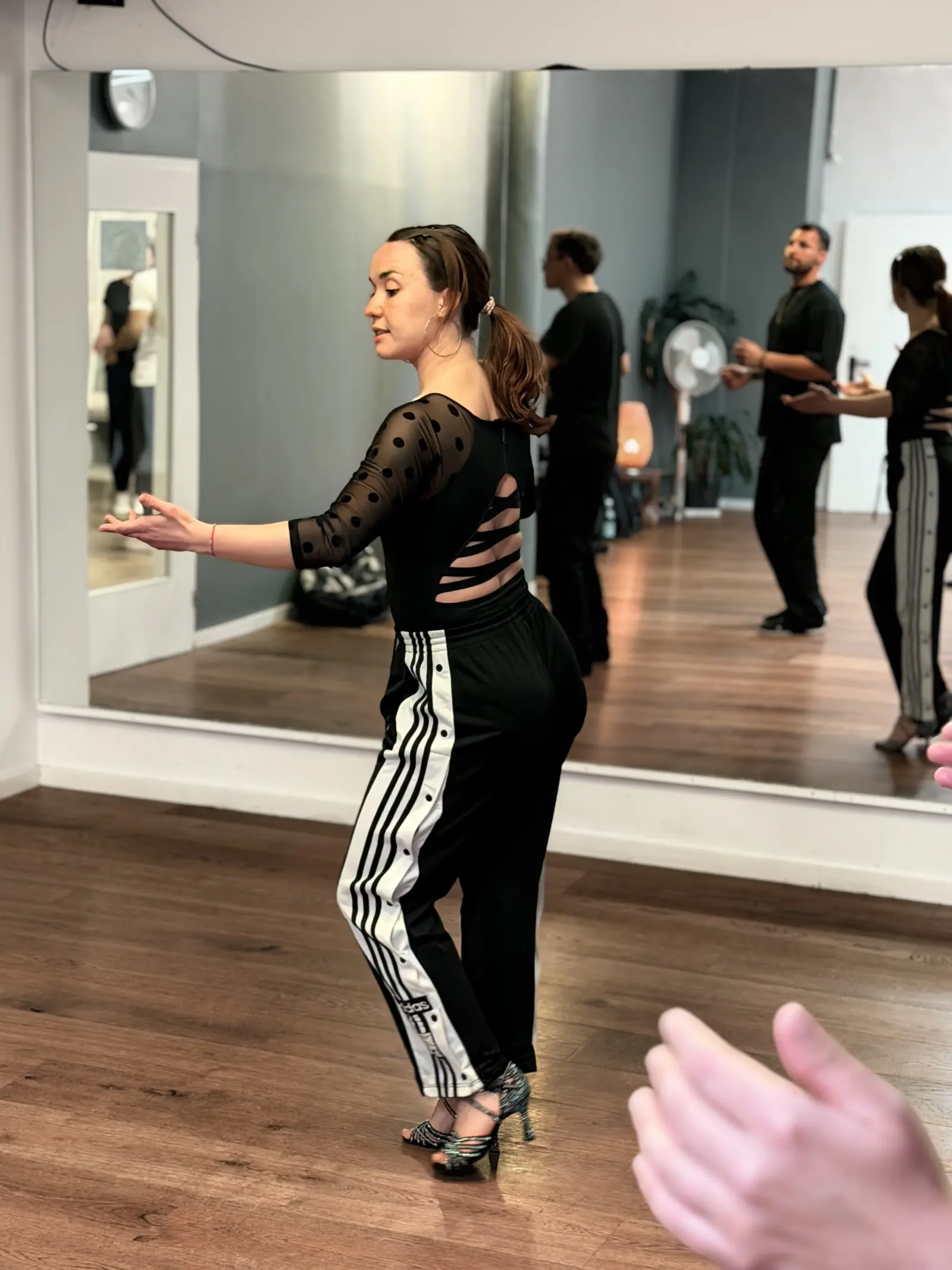 Lucy opening her arms in a body-movement drill for Salsa On 2