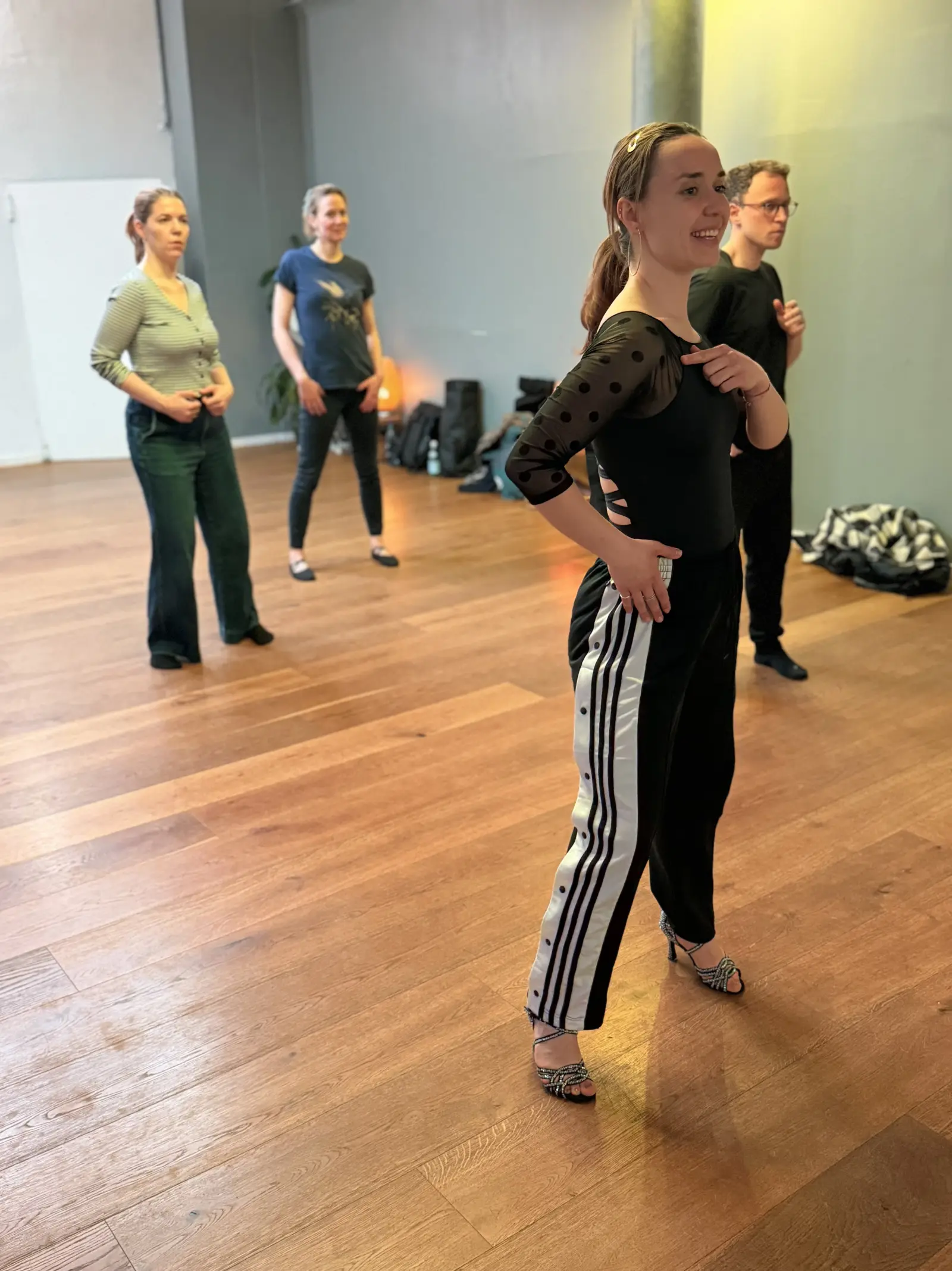Lucy mid-demonstration with students watching in the background