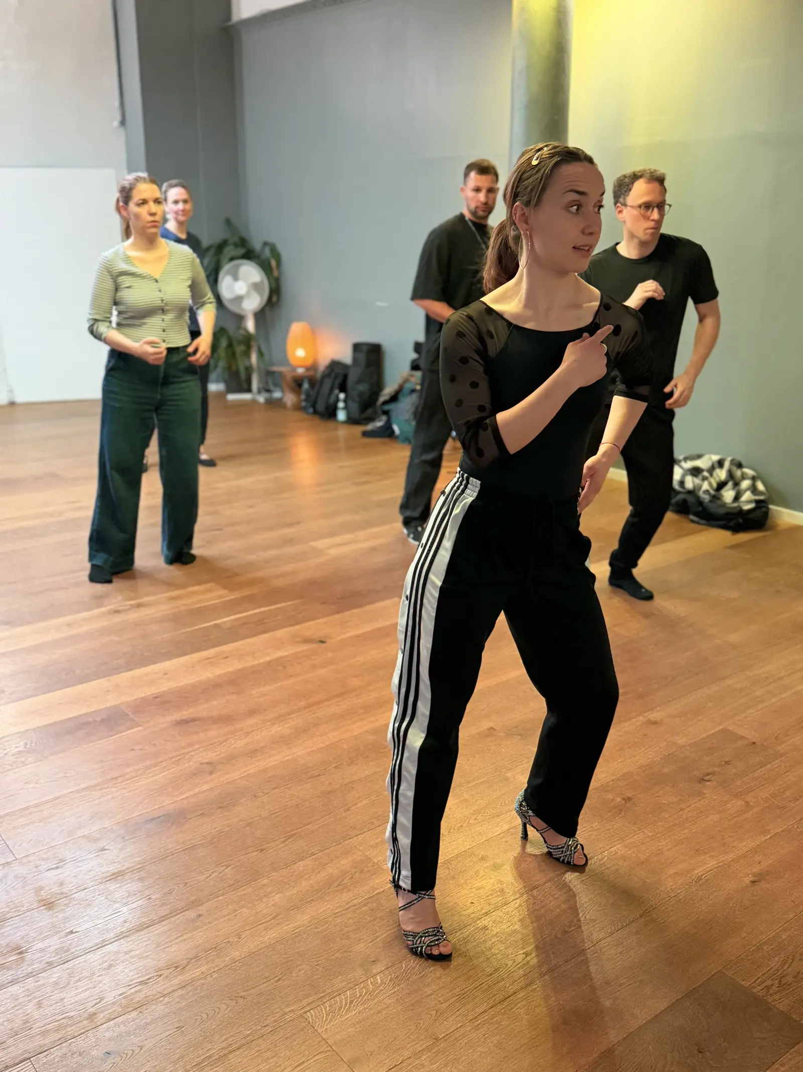 Lucy teaching a styling cue, students in line behind her